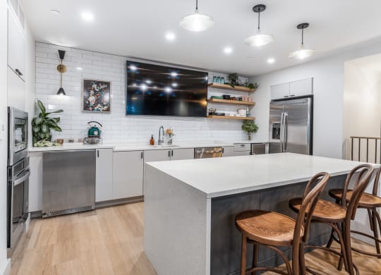 a kitchen with a large island and three chairs at The Commonwealth Building, Pennsylvania