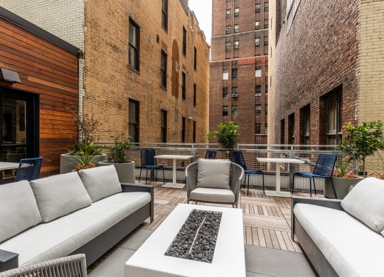 an outdoor patio with couches and chairs and tables at The Commonwealth Building, Pittsburgh, 15222