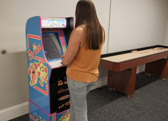 a girl playing an arcade game at The Washington at Chatham, Pittsburgh