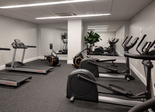 a gym with treadmills and exercise bikes at The Washington at Chatham, Pittsburgh