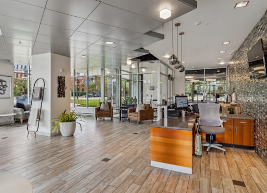 A modern office space with wooden floors and a brick wall.