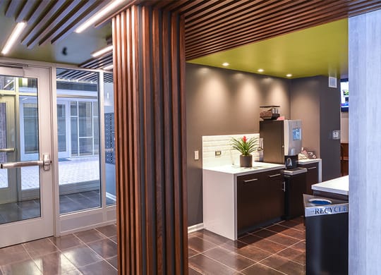 a view from the kitchen into the reception area with a wood column in the foreground at Walnut on Highland, Pittsburgh, PA