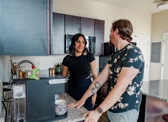 a man and a woman standing in a kitchen at Walnut on Highland, Pittsburgh, PA
