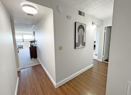 a view of the hallway of an apartment with hardwood floors at Walnut Towers at Frick Park, Pittsburgh, 15217