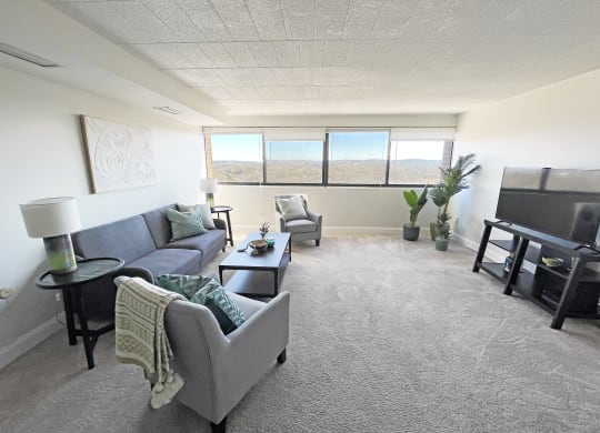a living room with a couch chairs and a television at Walnut Towers at Frick Park, Pittsburgh, PA