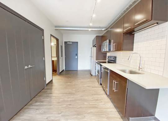 A kitchen with a sink and a refrigerator.at Bakery Living, Shadyside, Pittsburgh, PA 15206