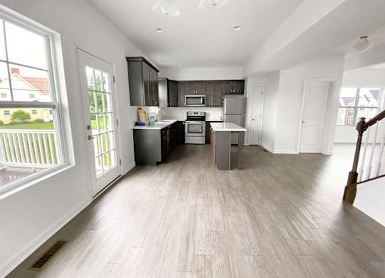 A kitchen with a refrigerator, oven, and microwave. at Highland Village, Ross Township, Pittsburgh, PA 15229