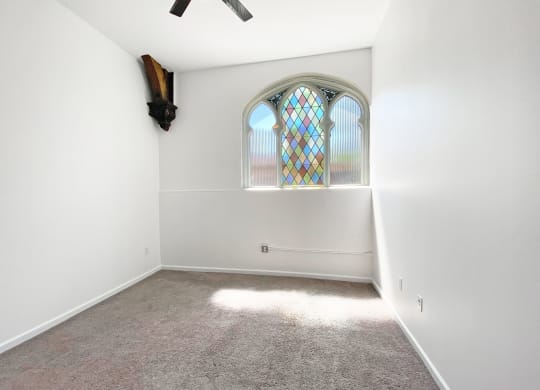 Carpeted Bedroom with Unique Window at University Commons, Pittsburgh 15213