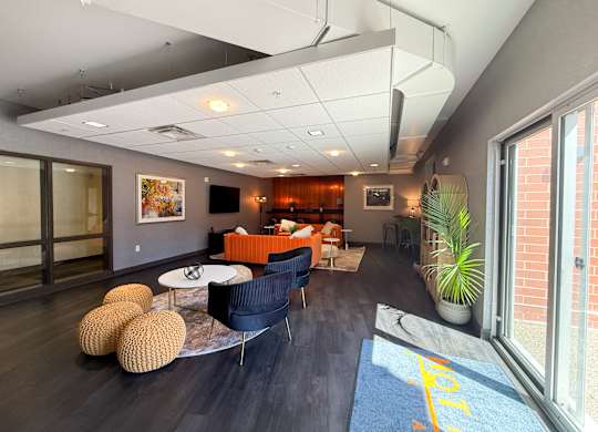 A living room with a blue rug and a yellow line on it. Hot Metal Flats apartments, Southside Pittsburgh, PA