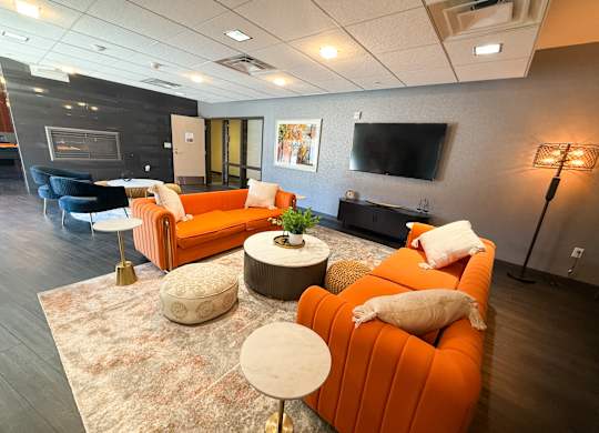 A living room with a fireplace and a television. Hot Metal Flats apartments, Southside Pittsburgh, PA
