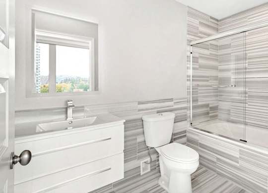 A white bathroom with a toilet, sink, and shower. at The Washington at Chatham, Pennsylvania, 15219