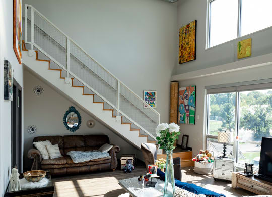 a view of the living room with the stairs leading up to the second floor