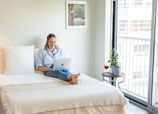 a woman sitting on her bed at Bakery Living in Pittsburgh, PA 15206