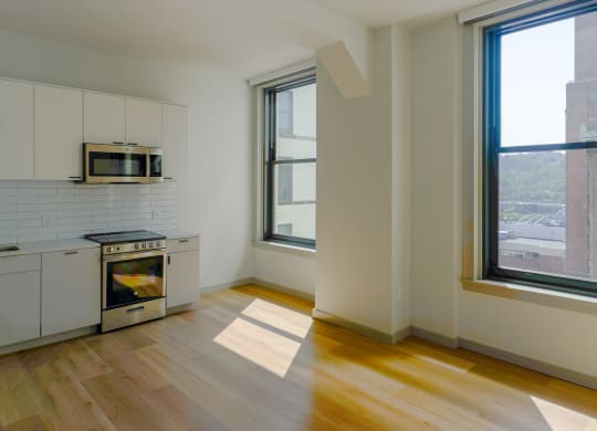 a kitchen with a large window and a stove and a microwave at The Commonwealth Building, Pittsburgh, 15222