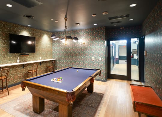 a game room with a pool table and a tv at The Commonwealth Building, Pittsburgh, 15222