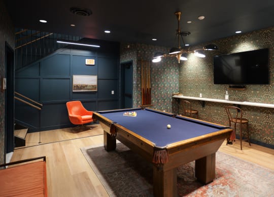 a game room with a pool table and a tv at The Commonwealth Building, Pittsburgh, 15222