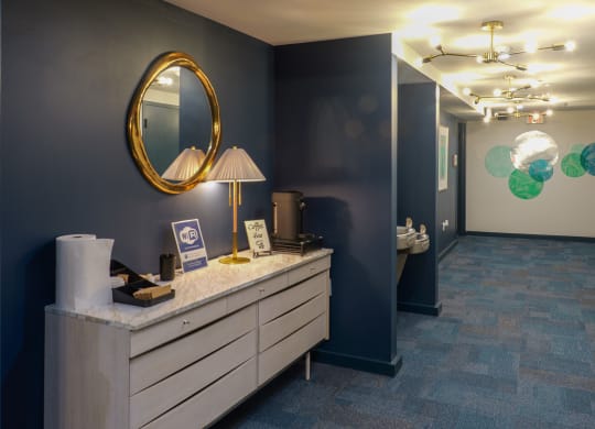 a hallway with a vanity with a mirror and a door to a bathroom at The Commonwealth Building, Pittsburgh, 15222