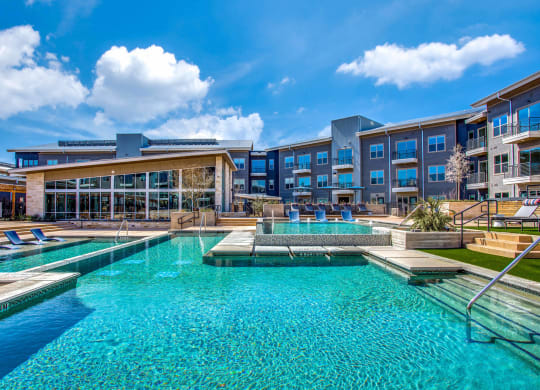 a large swimming pool with a building in the background at Trailhead, Austin Texas