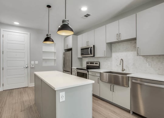 a kitchen with white cabinetry and stainless steel appliances at Trailhead, Texas