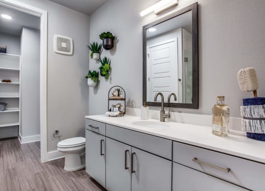 a bathroom with white cabinets and a white toilet at Trailhead, Austin