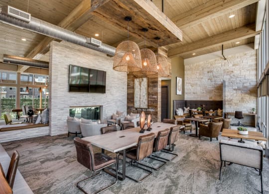 a large living room with a fireplace and a large wooden table at Trailhead, Texas, 78721