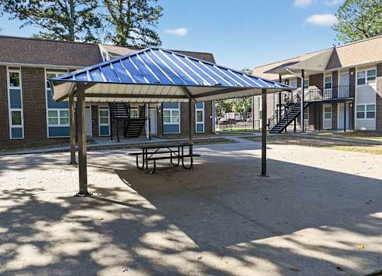 A Blue Shade Provided Over a Picnic Table at Fair Oaks Apartments, Little Rock, AR