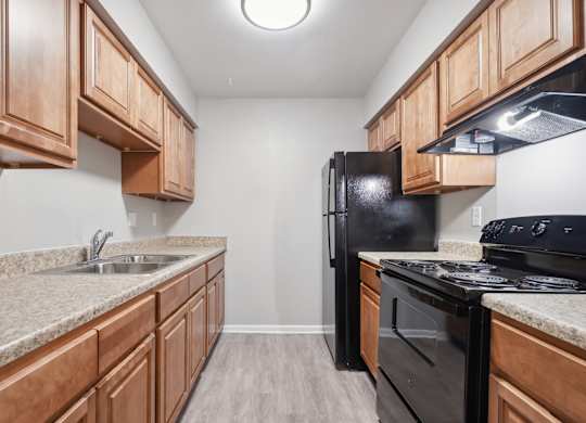 A Kitchen With Black Appliances at Fair Oaks Apartments, Little Rock, 72204