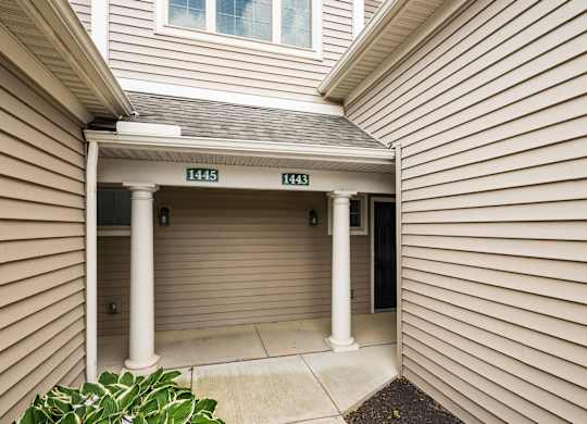 A house entrance with the numbers 1445 and 1443 on the pillars. at River View at Bexley Apartments, River View at Bexley, OH, 43209