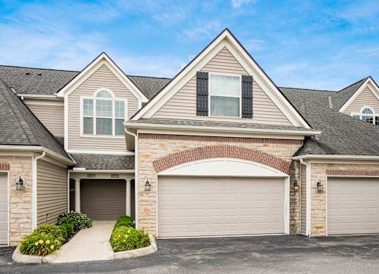 A house with a garage and a driveway. at River View at Bexley Apartments, River View at Bexley, Ohio