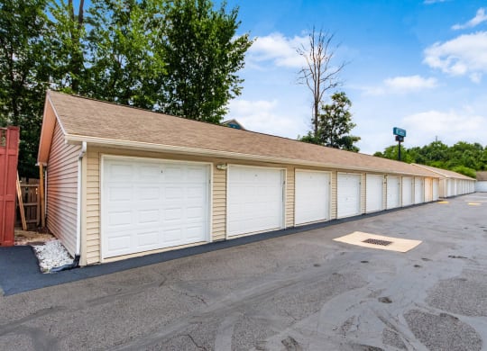a row of white garage doors on the side of a building