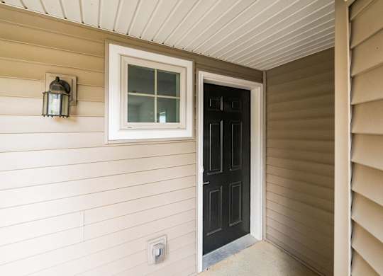 A black door is open to a white room. at River View at Bexley Apartments, River View at Bexley, OH