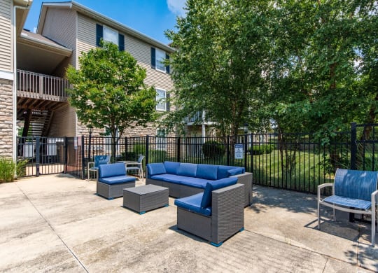 our apartments have a large patio with furniture and a fence