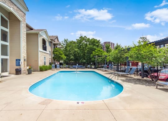 the preserve at ballantyne commons resort style swimming pool with trees and apartment buildings