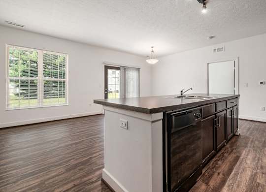 A kitchen with dark wood floors and white walls. at River View at Bexley Apartments, Ohio, 43209