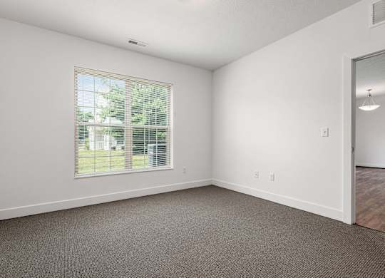 A room with a window and a door. at River View at Bexley Apartments, River View at Bexley, Ohio