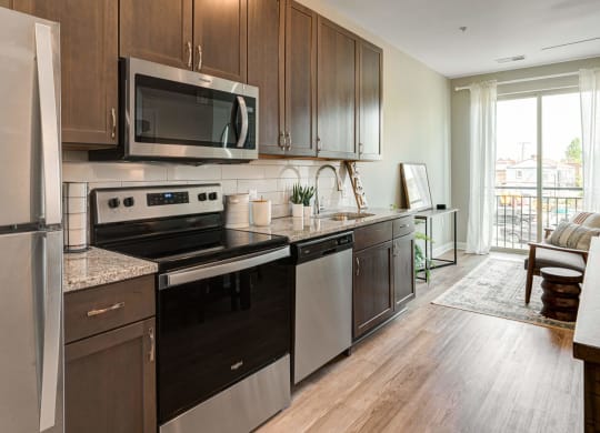 a kitchen with stainless steel appliances and wooden cabinets at Adelphi Quarter, Columbus
