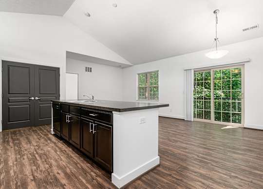 A kitchen with dark brown cabinets and white countertops. at River View at Bexley Apartments, River View at Bexley 43209