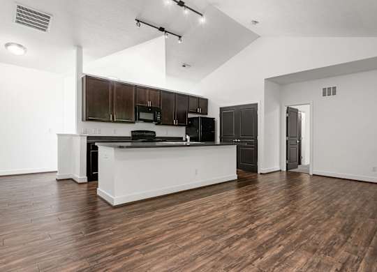 A kitchen with dark wood cabinets and black appliances. at River View at Bexley Apartments, River View at Bexley 43209