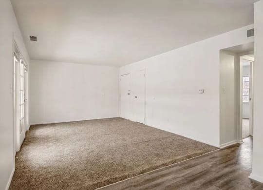 a room with a carpeted floor and white walls