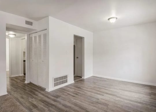 a room with a wooden floor and white walls
