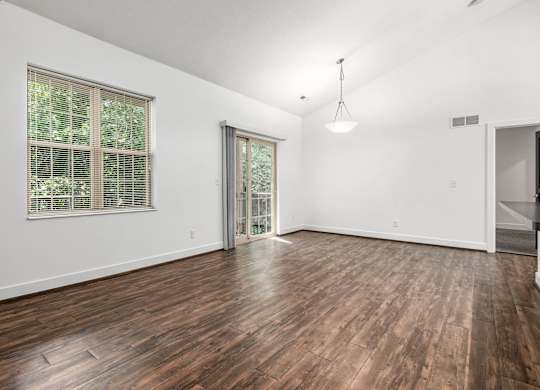 A room with wooden flooring and a window with blinds. at River View at Bexley Apartments, River View at Bexley, OH, 43209