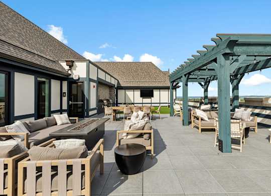 A patio with wooden furniture and a green pergola.