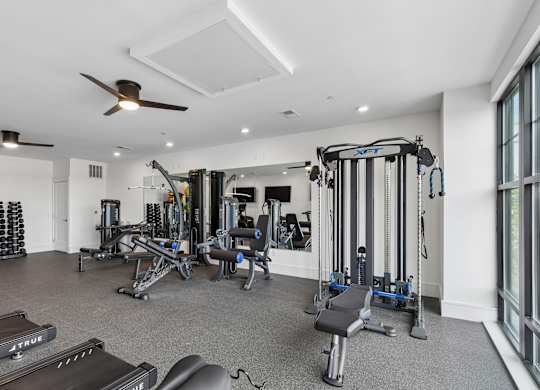 A spacious home gym with a variety of equipment.