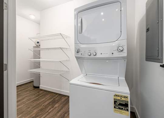 A white microwave oven with a sticker on it. at River View at Bexley Apartments, River View at Bexley, Ohio