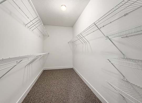 Empty walk-in closet with shelves and carpeted floor. at River View at Bexley Apartments, Ohio, 43209