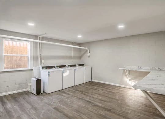 a room with two washers and a sink