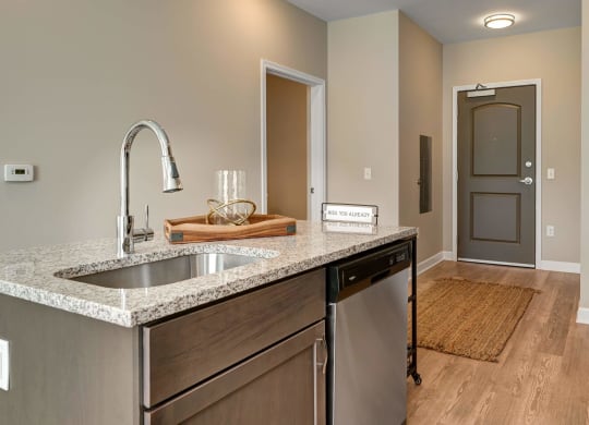 a kitchen with a sink and a door to a hallway at Adelphi Quarter, Columbus, OH, 43203