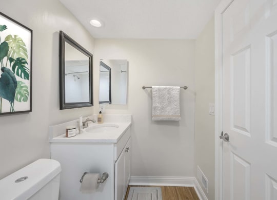 a bathroom with a sink and a mirror at Harpers Point Apartments, Cincinnati, Ohio