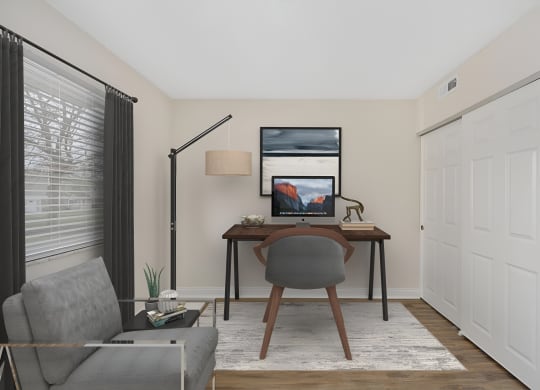 a home office with a computer desk and chair at Harpers Point Apartments, Cincinnati
