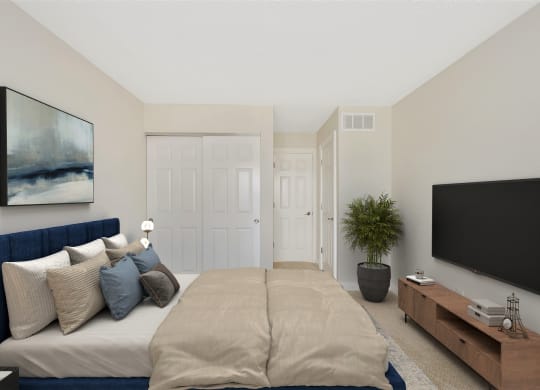 a bedroom with a large bed in front of a tv at Harpers Point Apartments, Ohio